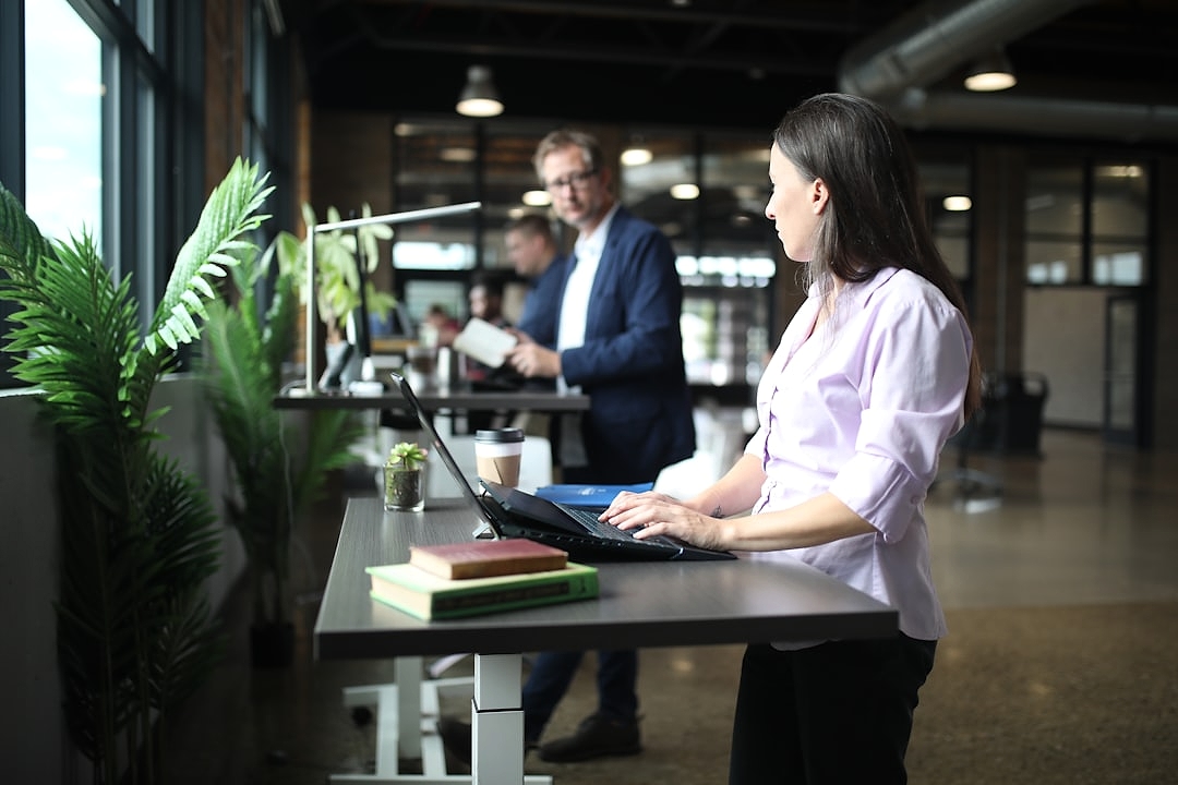 Employees doing office stretches in a common area